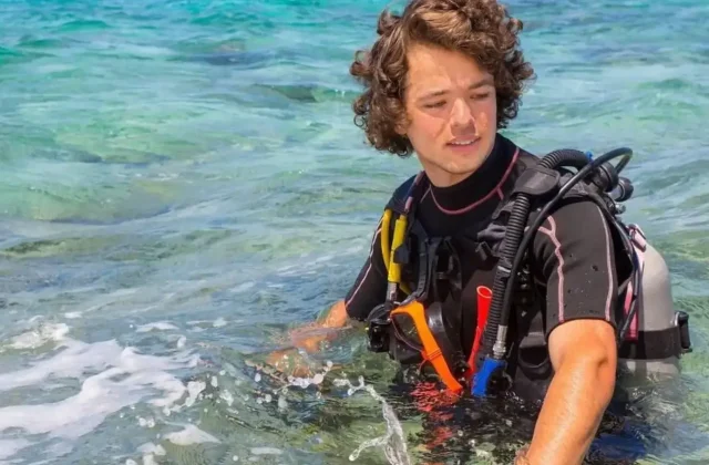 Diver in full gear in shallow water