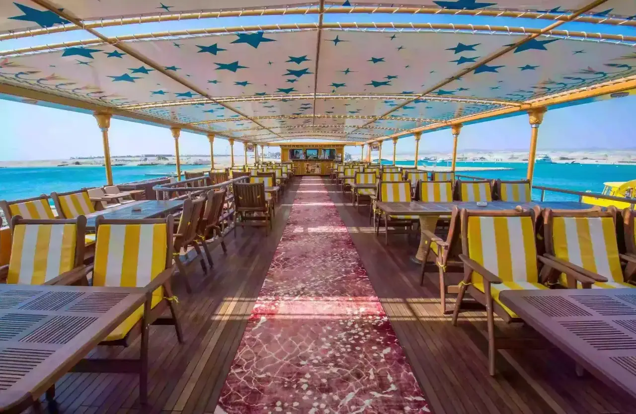 Shaded boat deck with tables and striped deck chairs