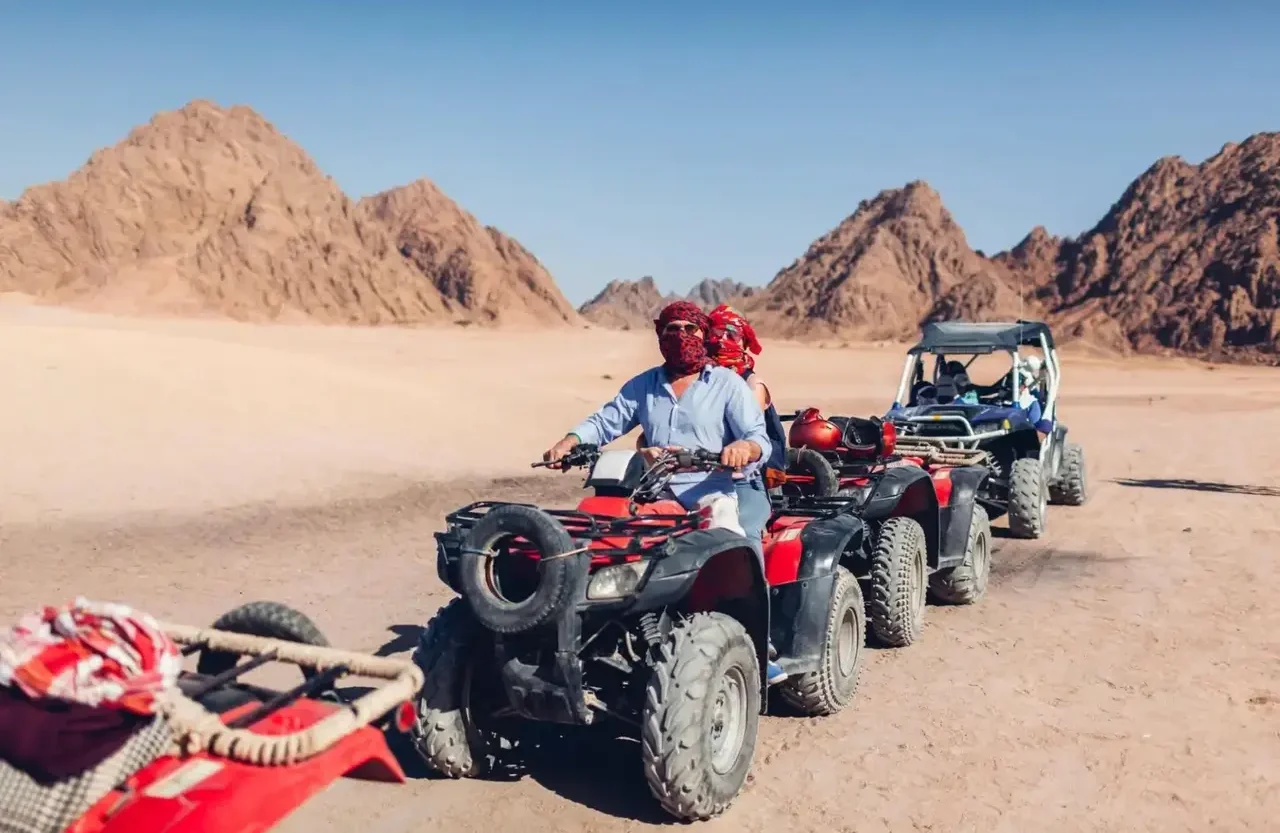 Group of quad bikes and a buggy parked together in the Hurghada desert
