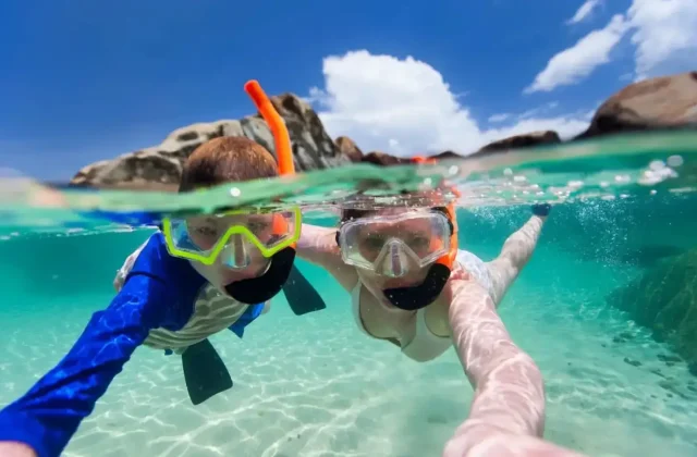 Mother and child floating at the surface in clear Red Sea water