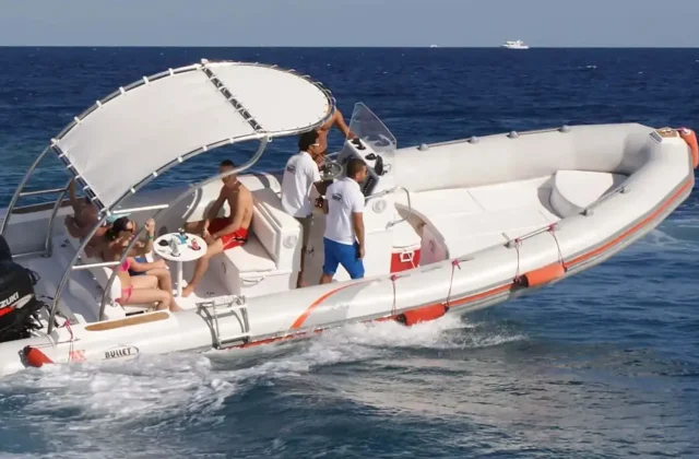 Fast boat with passengers on deep blue sea off Hurghada